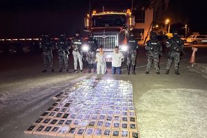 Los detenidos junto a la droga decomisada que era trasladada en un camión.