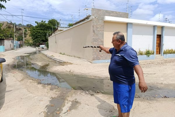 Ángel Espinoza, residente de la zona baja, muestra el recorrido de las aguas negras en el barrio.