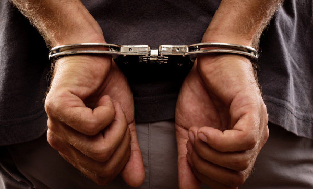 depositphotos_28109403-stock-photo-arrested-man-handcuffed-hands-at