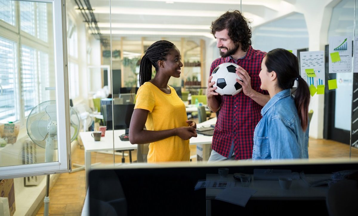 Group of graphic designers interacting with each other in office