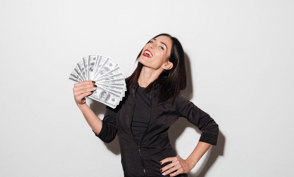 Happy woman with red lips holding money.