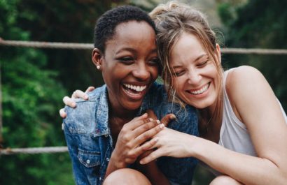 Happy friends holding each other
