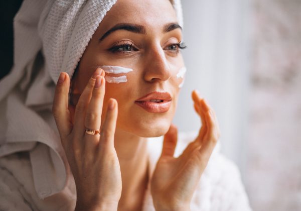 Woman applying face cream