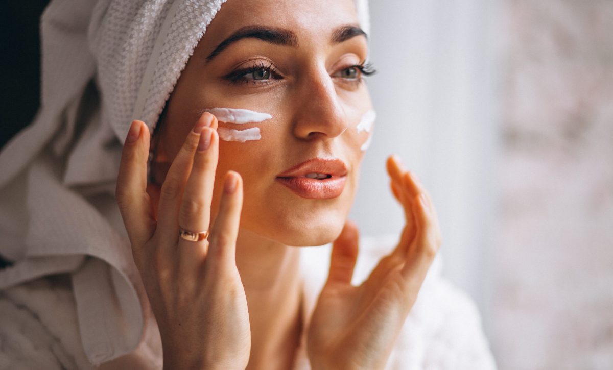 Woman applying face cream