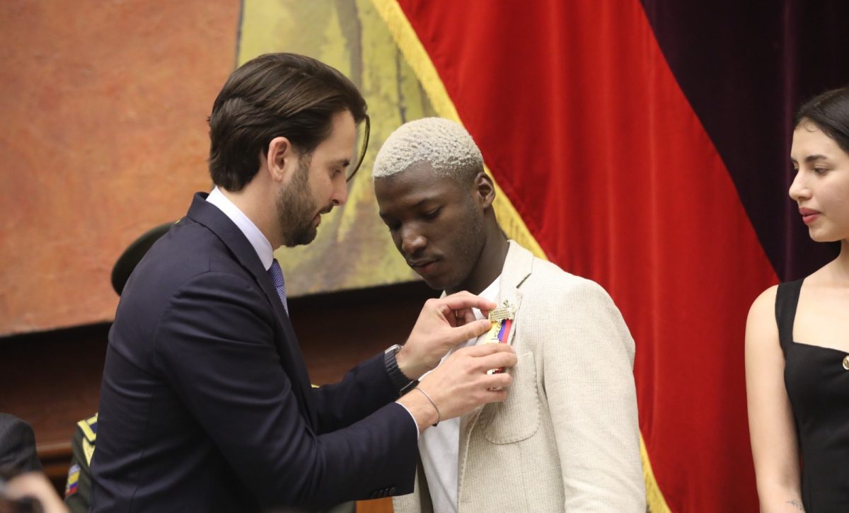 Moisés Caicedo recibe la condecoración por parte de Niels Olsen, presidente de la Asamblea Nacional.