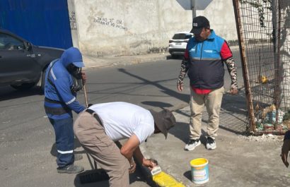 Vecinos de la avenida 108 en Los Esteros mientras pintan los bordillos para mejorar la imagen del sector.